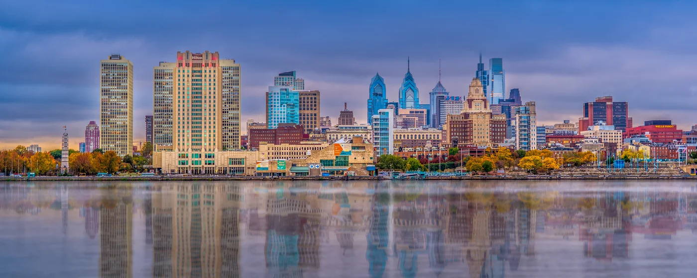 Philadelphia skyline at sunset reflected in the Delaware River
